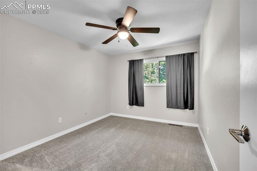 Image 22 of 49: Carpeted spare room featuring baseboards and ceiling fan