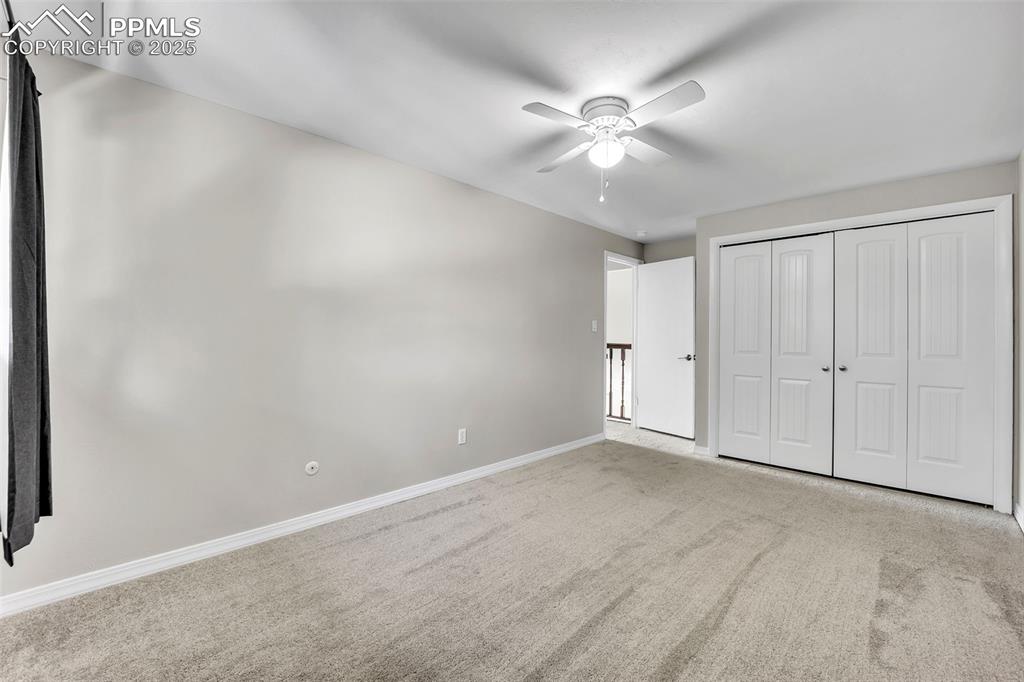 Image 25 of 49: Unfurnished bedroom featuring carpet floors, a ceiling fan, and a closet