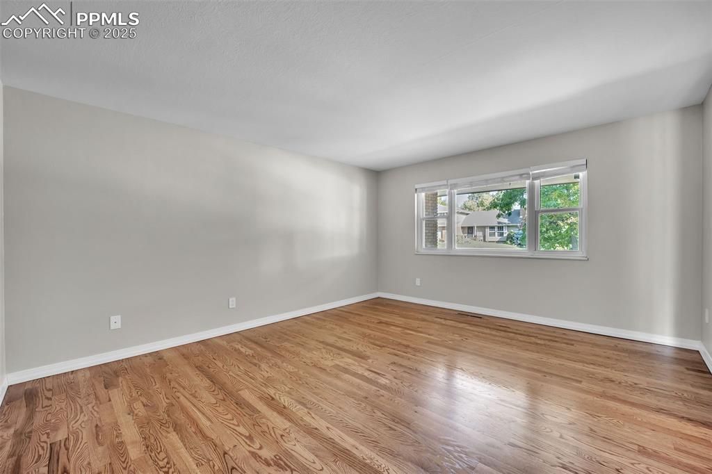 Image 3 of 49: Unfurnished room featuring light wood-style floors and baseboards
