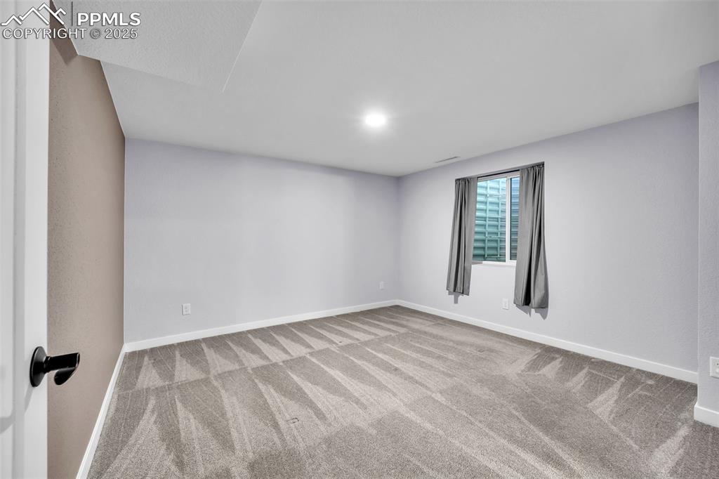 Image 32 of 49: Spare room featuring light colored carpet and baseboards