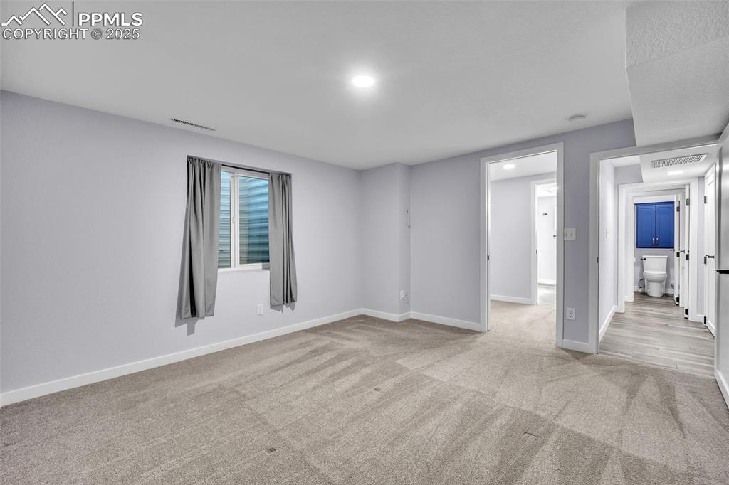 Image 33 of 49: Spare room featuring light colored carpet and baseboards
