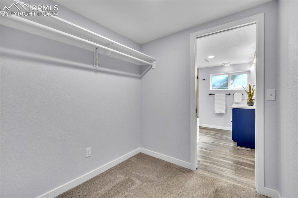 Image 34 of 49: Spacious closet featuring light carpet