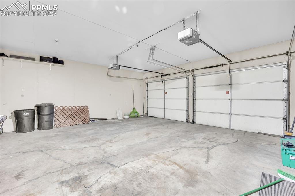 Image 39 of 49: Garage with a garage door opener