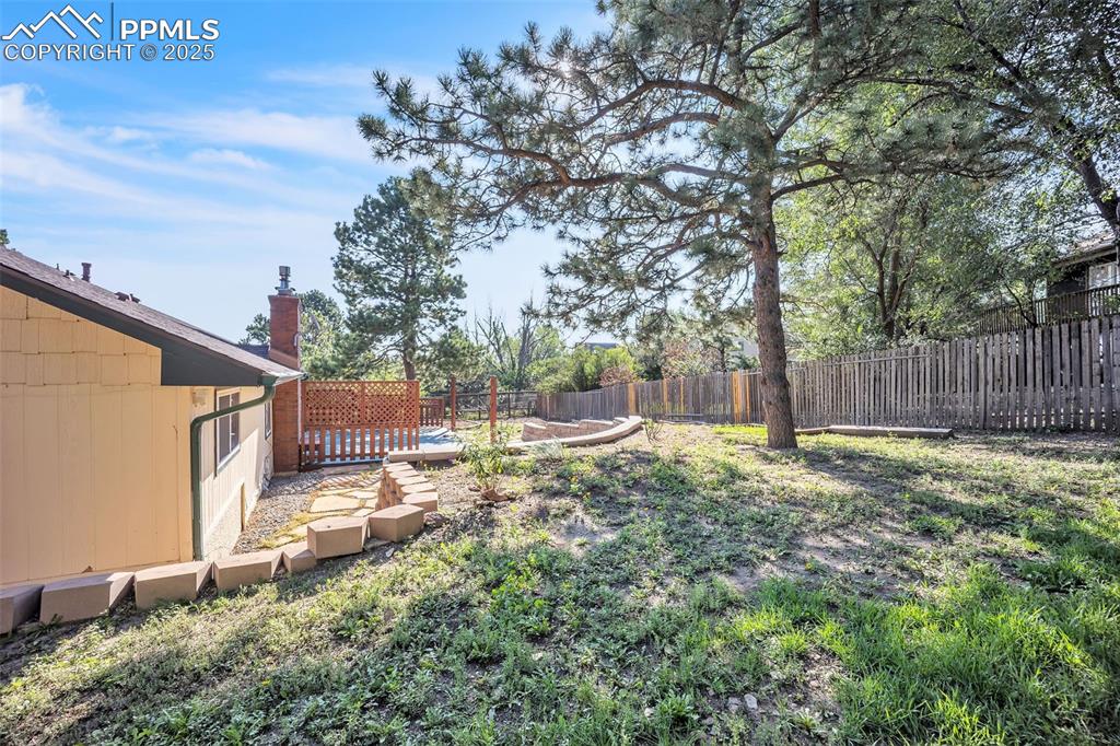 Image 45 of 49: Fenced backyard featuring a wooden deck