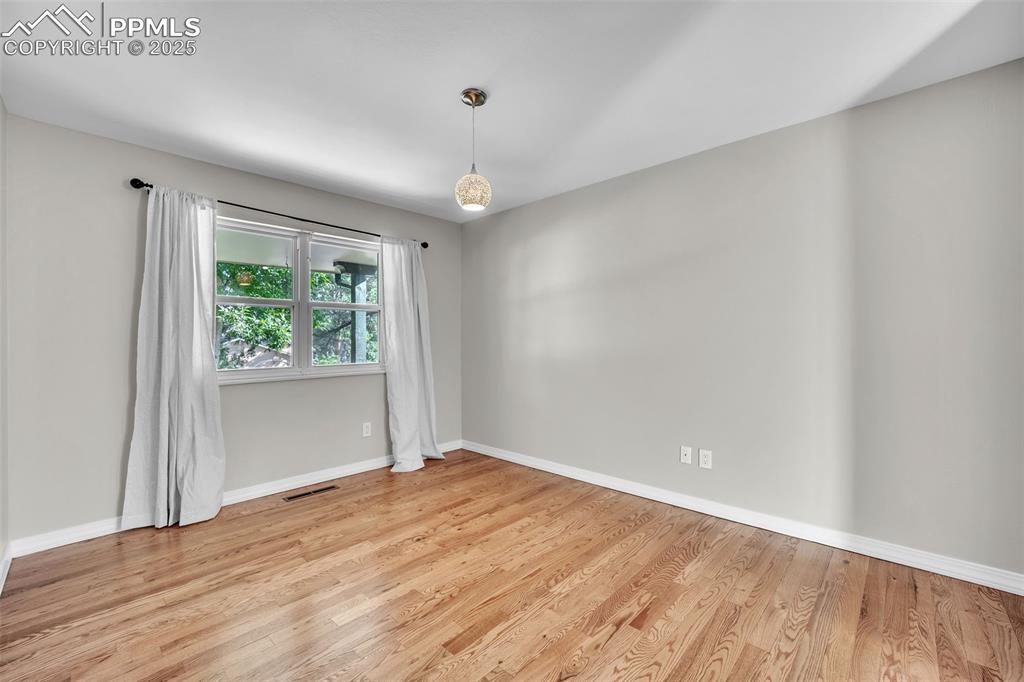 Image 5 of 49: Unfurnished room with light wood-type flooring