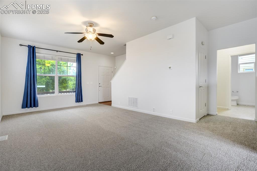 Image 11 of 50: Living room and hallway to half bath