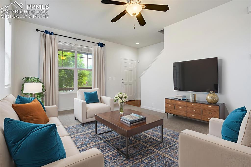 Image 17 of 50: Virtually staged living room toward front door