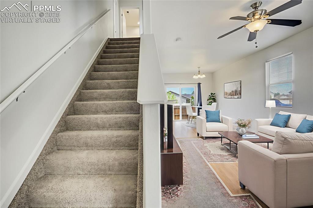 Image 4 of 50: Virtually staged living room and dining area from entry