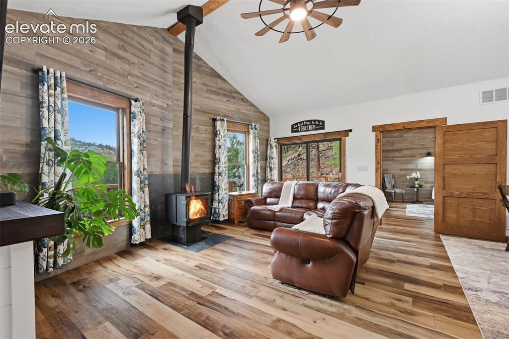 Image 11 of 33: Vaulted ceilings with wood burning stove