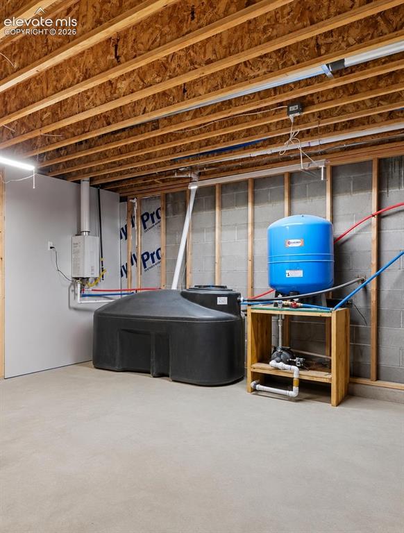 Image 29 of 33: Storage Room with instant hot water heater and cistern
