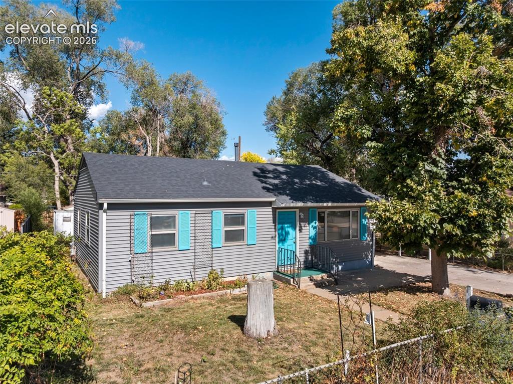 Image 1 of 45: Exterior featuring horizontal siding, a gabled roof, and vibrant blue shutt