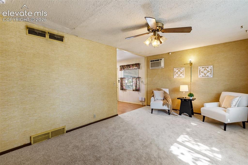 Image 10 of 45: Carpeted flooring, textured wall finishes, ceiling fan with integrated ligh