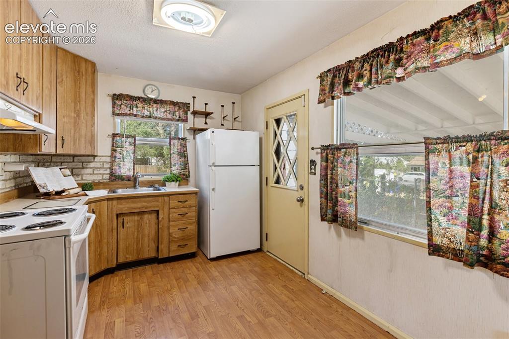 Image 13 of 45: Wood-finish flooring with coordinating wood-finish cabinetry