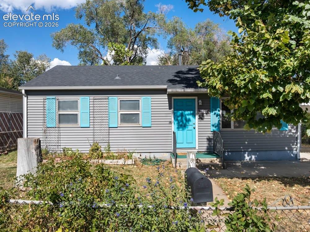 Image 2 of 45: Gray horizontal siding with a contrasting blue entry door and shutters