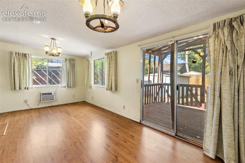Image 31 of 45: Wood-finish flooring throughout, multiple windows, two ceiling-mounted ligh