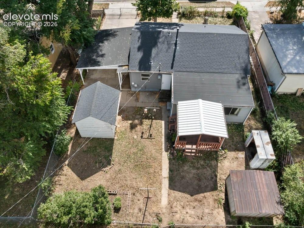 Image 40 of 45: Property featuring a covered patio, a detached shed with a shingle roof, an