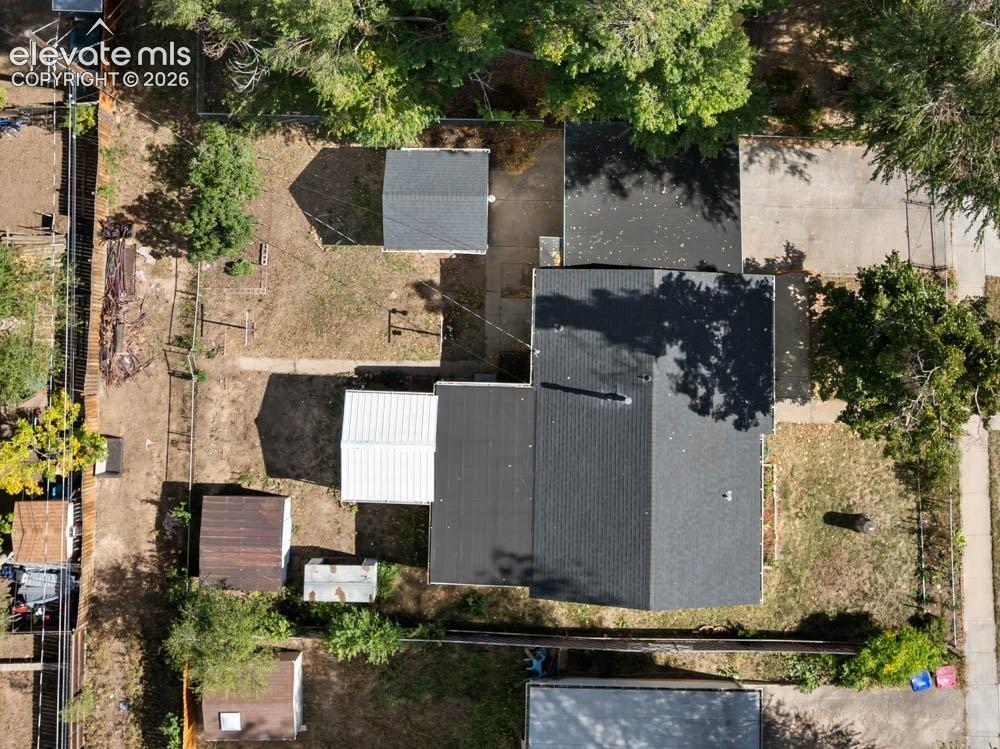 Image 41 of 45: Expansive lot featuring multiple outbuildings, a detached garage, and matur