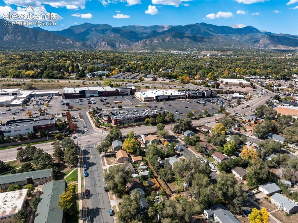Image 45 of 45: Mountain backdrop and urban landscape with commercial properties