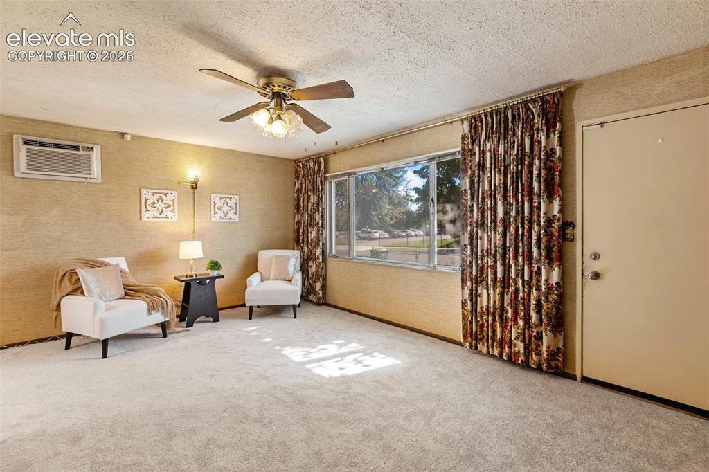 Image 9 of 45: Light-toned carpeting, ceiling fan with integrated lighting, wall-mounted a
