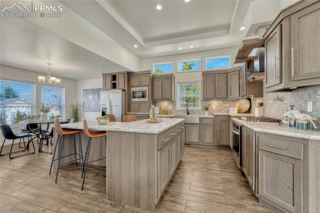 Image 10 of 48: Clerestory windows, recessed and under cabinet lighting makes the space eve
