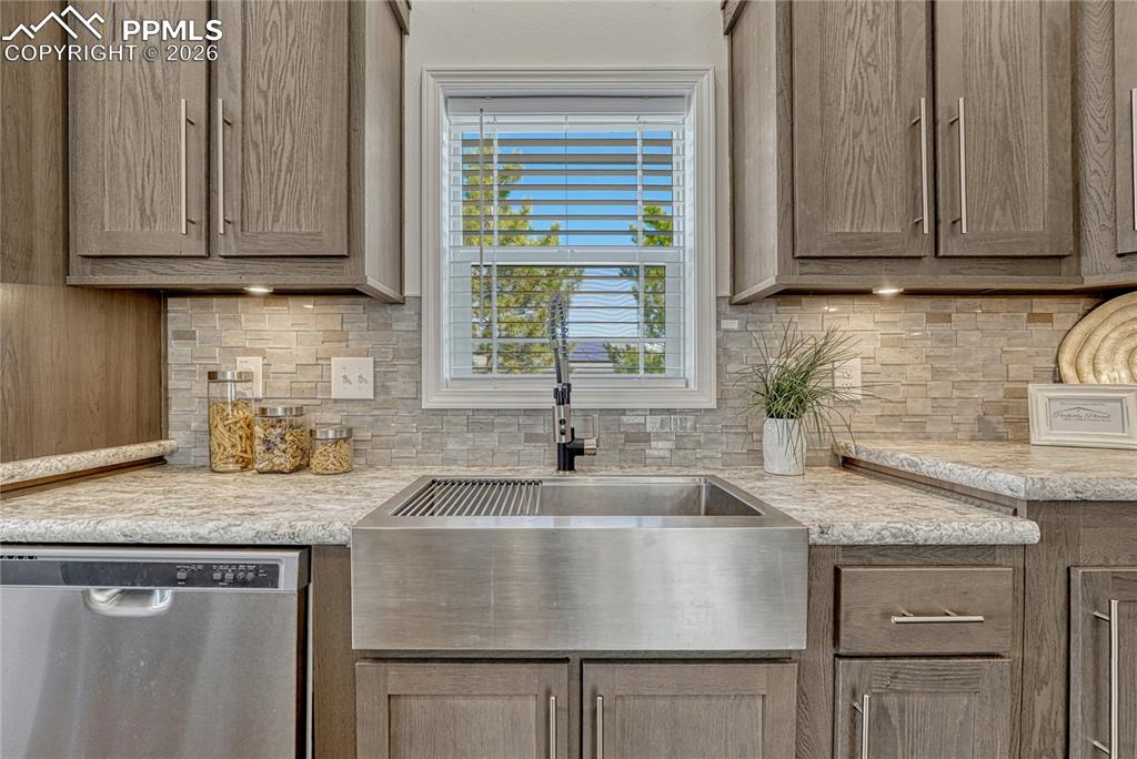 Image 12 of 48: Stainless steel farm sink with a flexible sink faucet, sprayer and removabl