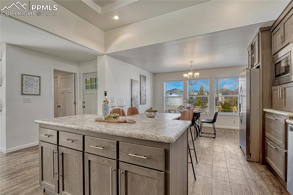 Image 13 of 48: Across the kitchen, off the entry is the laundry room with access to the ga