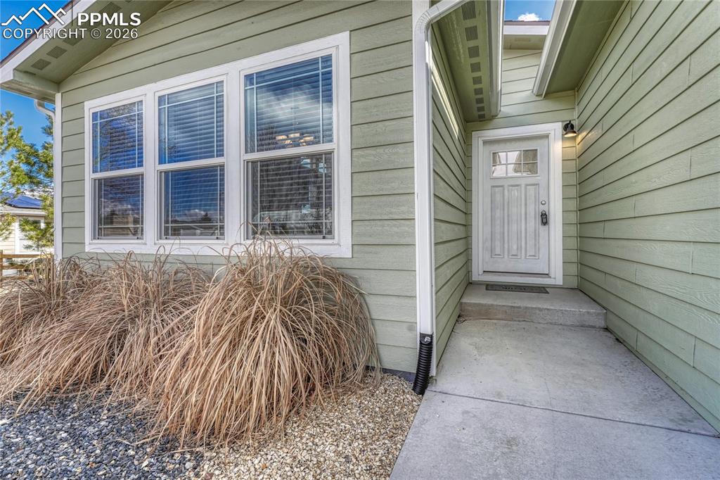 Image 2 of 48: Wood siding and a large set of front windows for the dining and kitchen spa