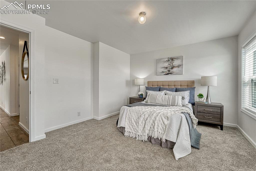 Image 23 of 48: Large primary bedroom at the back of the home for extra privacy