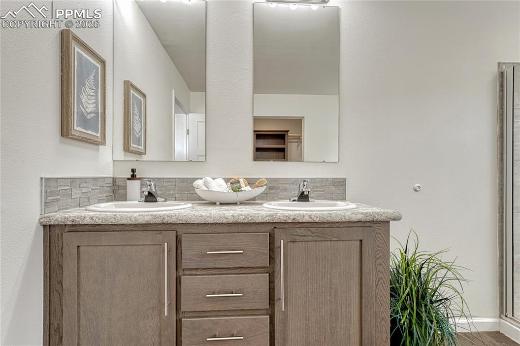 Image 28 of 48: Each vanity has its own mirror and lighting with matching countertop and ba