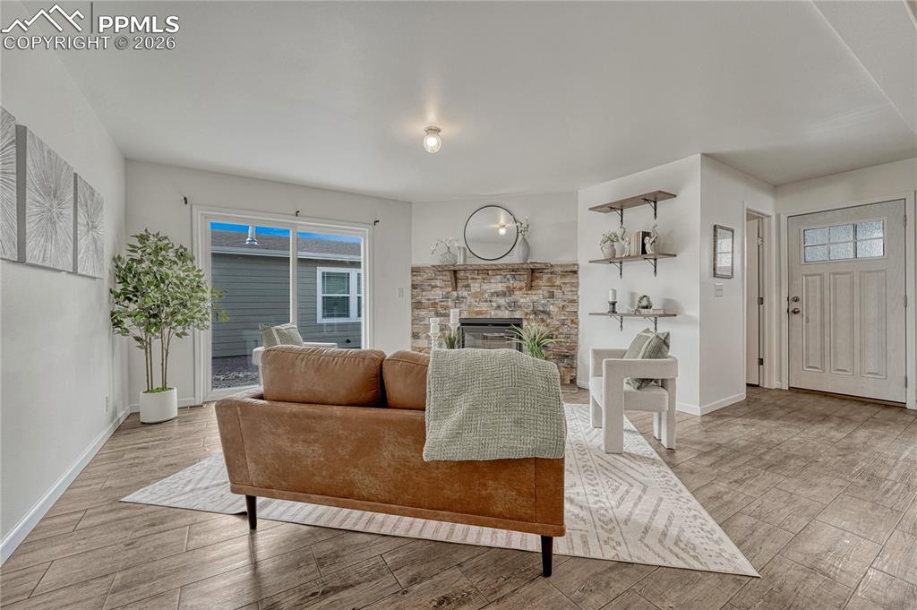 Image 31 of 48: Living room also offers additional shelving to the right of the stone firep