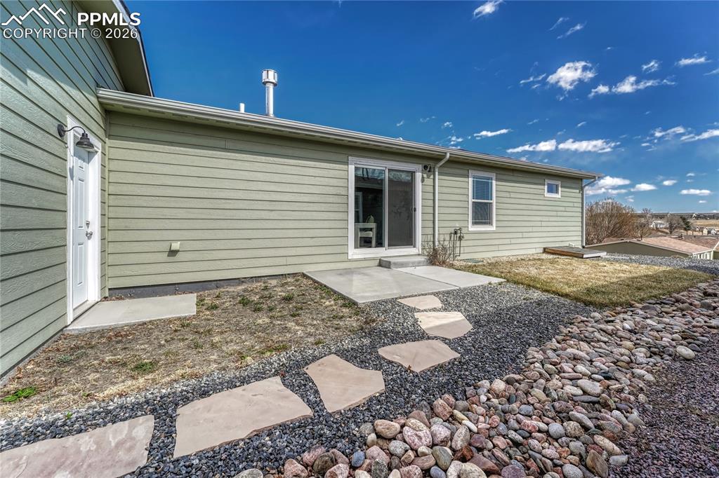 Image 33 of 48: Walk out to the side yard where you have a concrete patio, flagstone walkwa