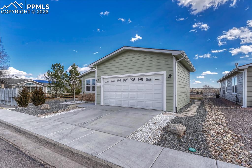 Image 37 of 48: Two car garage and driveway can accommodate 4 cars total
