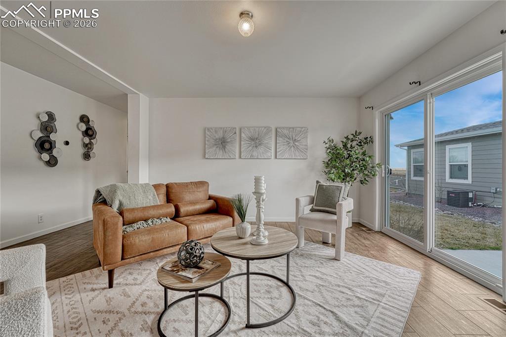 Image 5 of 48: The living space offers a sliding glass door that walks out onto the patio 