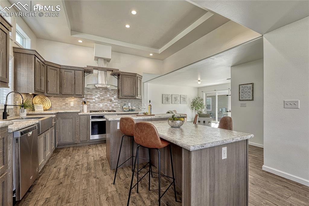 Image 8 of 48: Double sided breakfast bar island and stainless steel whirlpool appliances 