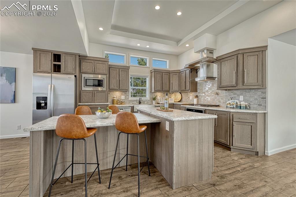 Image 9 of 48: Massive amounts of cabinet storage and full height tile backsplash for adde