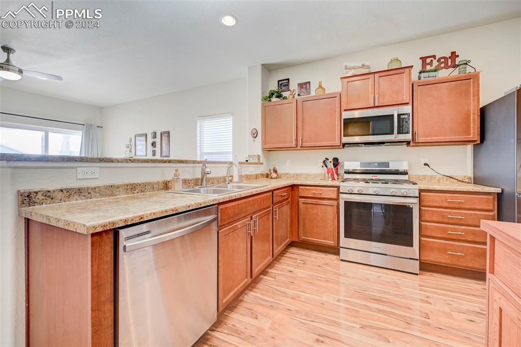 Image 10 of 45: Kitchen with light hardwood / wood-style flooring, a healthy amount of sunl