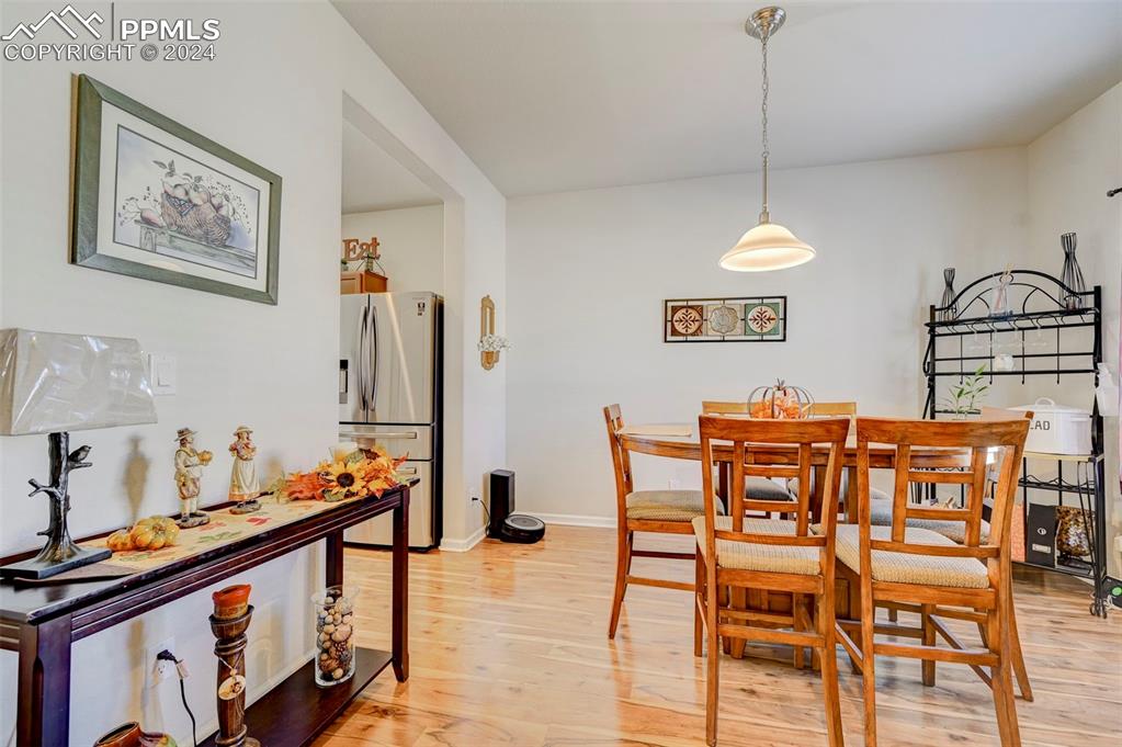 Image 14 of 45: Dining area with light hardwood / wood-style floors
