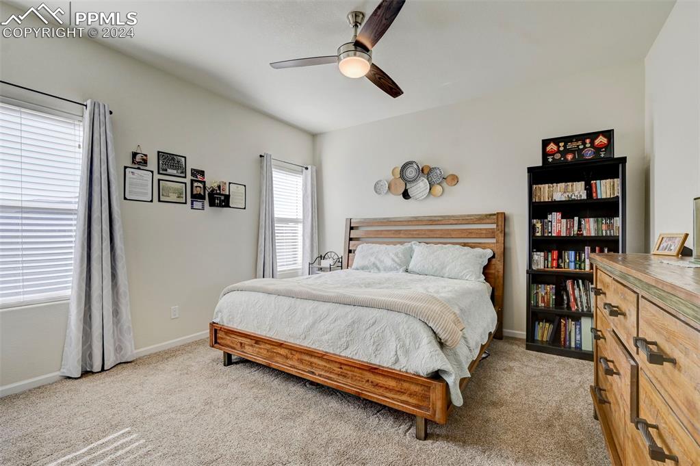 Image 16 of 45: Bedroom featuring light colored carpet and ceiling fan