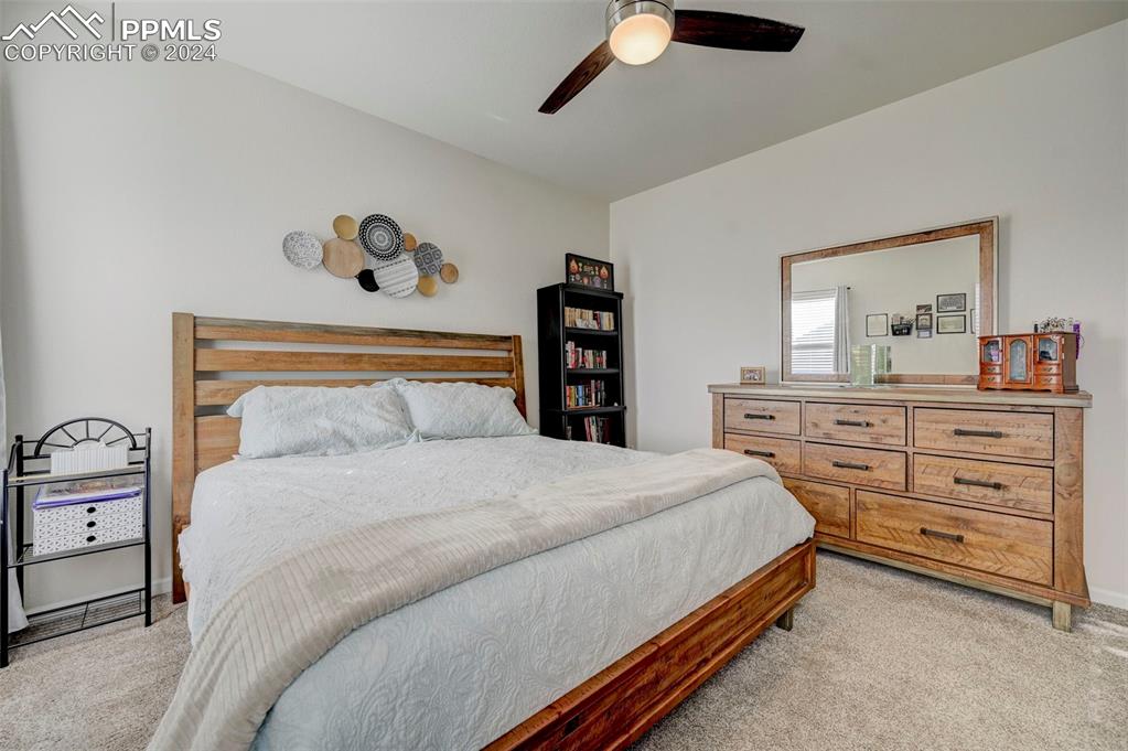 Image 17 of 45: Bedroom featuring light carpet and ceiling fan