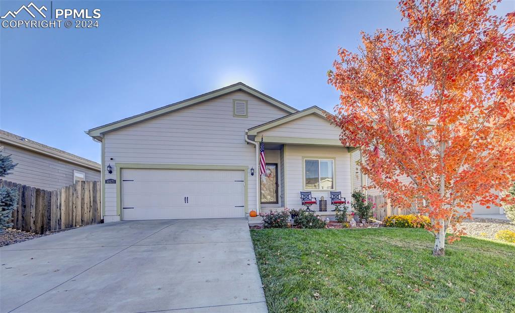 Image 2 of 45: Ranch-style home featuring a front yard and a garage