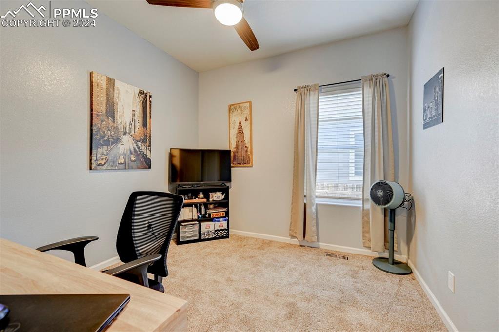 Image 21 of 45: Office space featuring carpet and ceiling fan