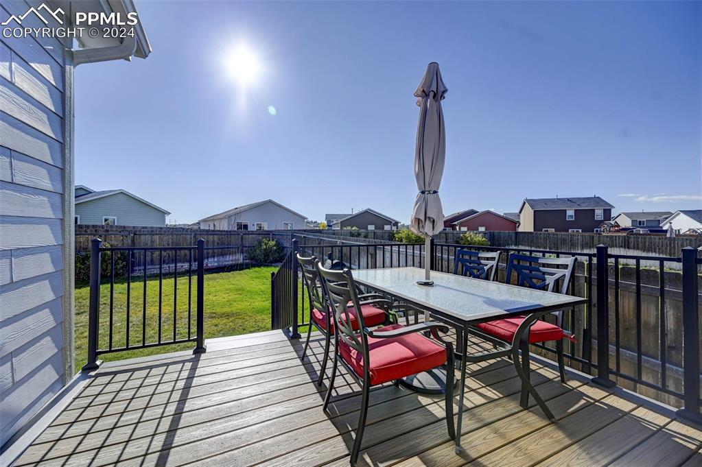 Image 24 of 45: Wooden deck featuring a yard