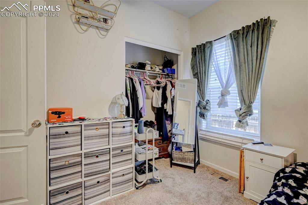 Image 4 of 45: Walk in closet with light colored carpet