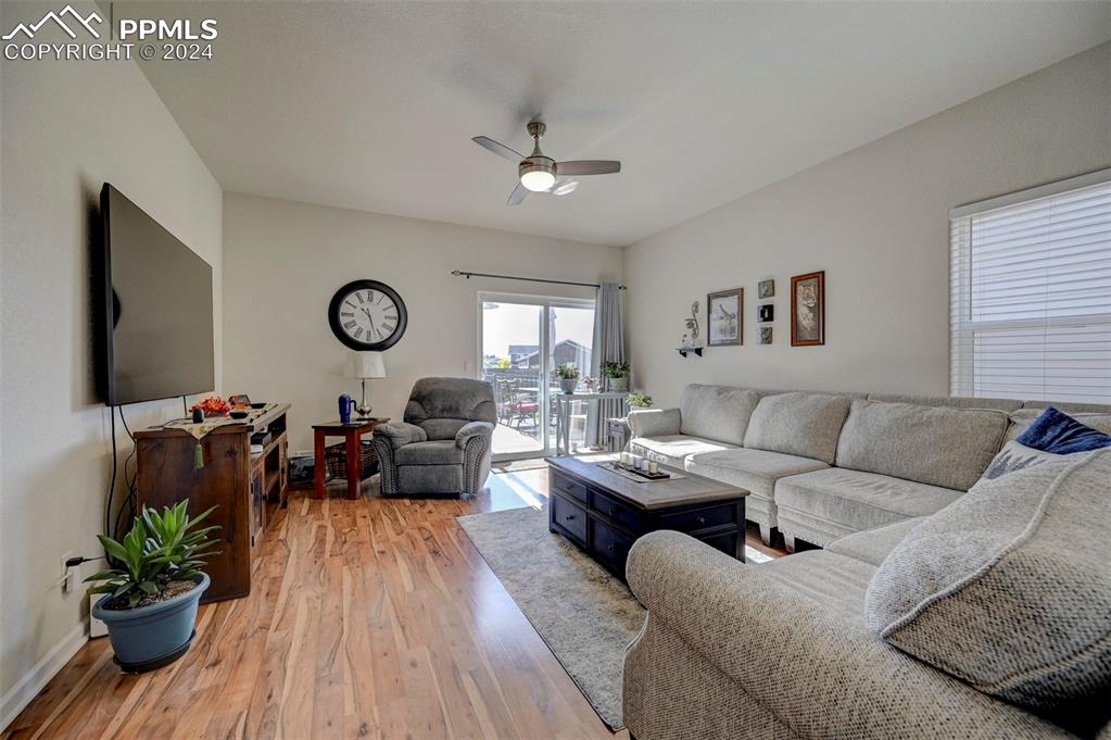 Image 5 of 45: Living room with light wood-type flooring and ceiling fan