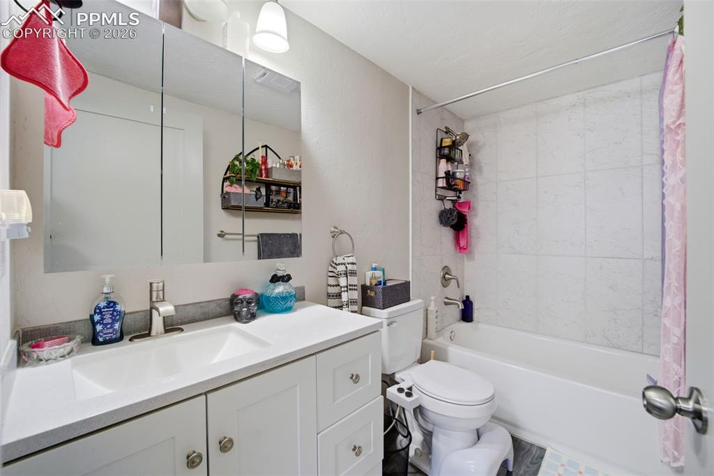 Image 10 of 35: Full bath with vanity and shower / bath combo