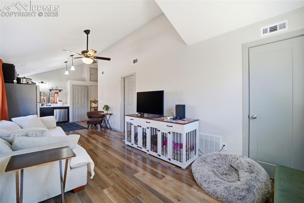 Image 16 of 35: Living room featuring lofted ceiling, ceiling fan, and LVP floors