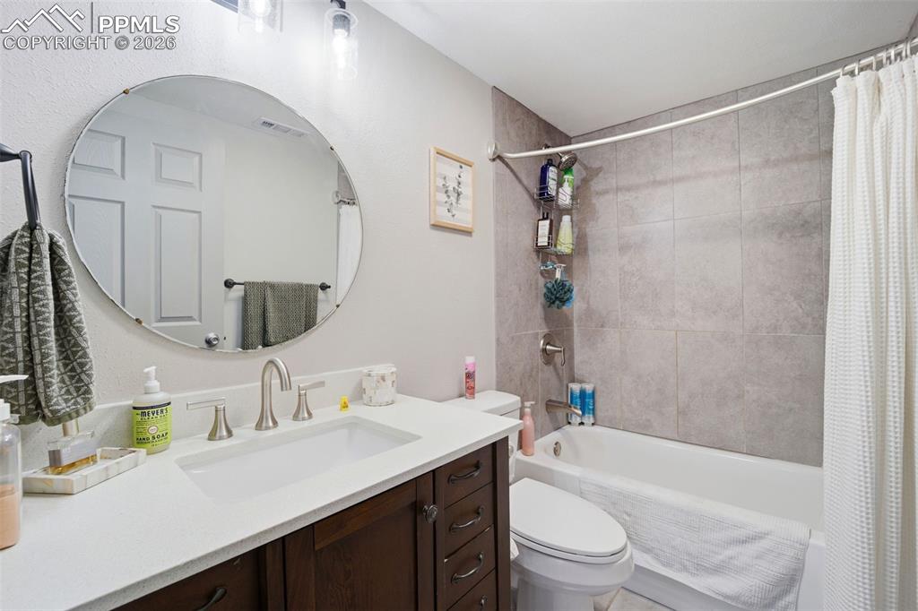 Image 24 of 35: Kitchen with stainless steel appliances, open shelves, and lofted ceiling