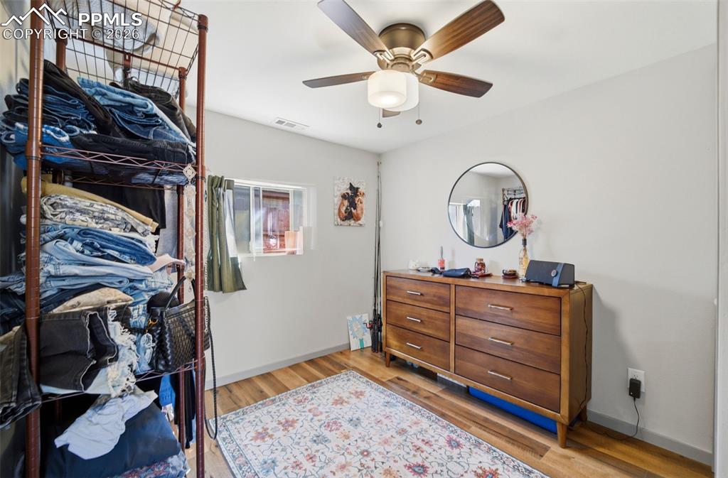 Image 27 of 35: Bedroom with LVP floors and baseboards