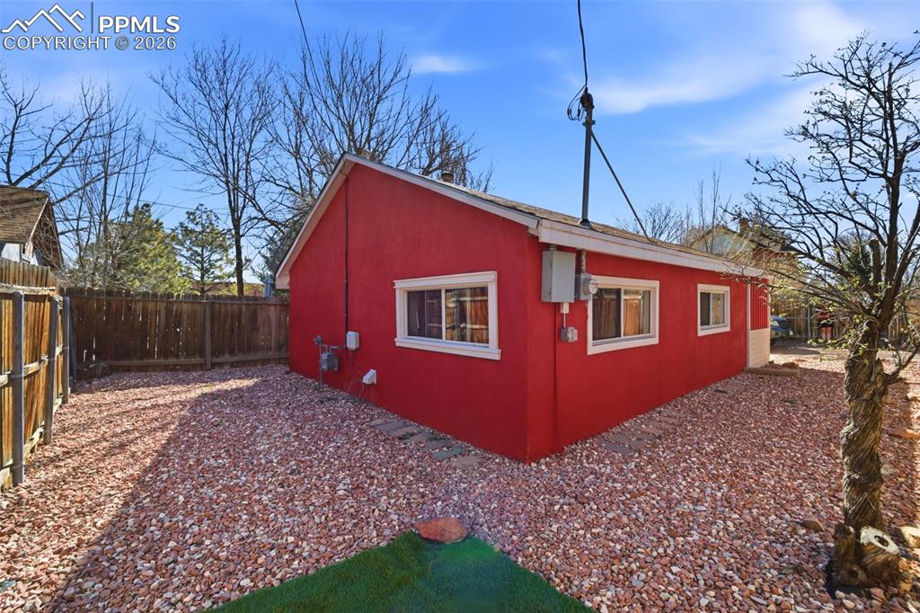 Image 30 of 35: View of cottage structure with a fenced backyard