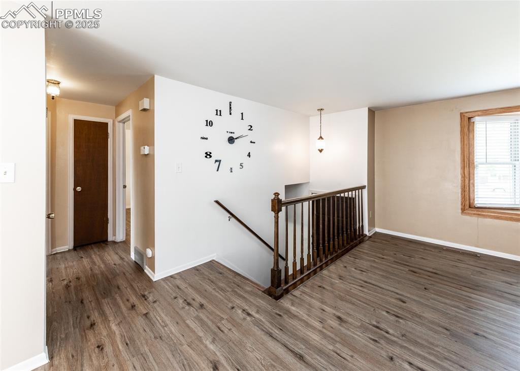 Image 2 of 22: Stairs featuring wood finished floors and baseboards